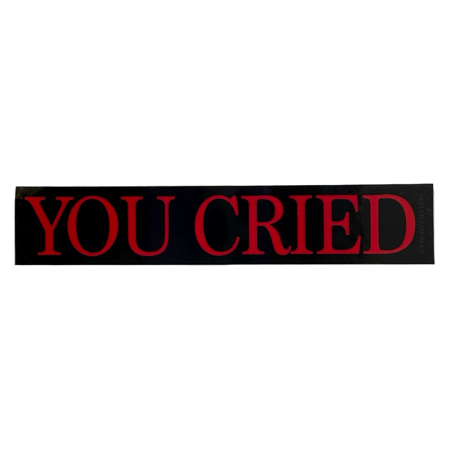 Red and black sticker with “you cried” text on a white background