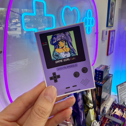 hand holding a purple game console sticker 