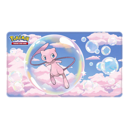 A rectangular Pokémon Trading Card Game playmat featuring the pink Mew character floating inside a large iridescent bubble against a sky-blue background with pink clouds and smaller bubbles.