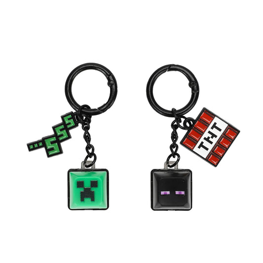 Two Minecraft-themed keychains on a plain white background. One keychain has a green Creeper pendant, and the other has a TNT pendant.