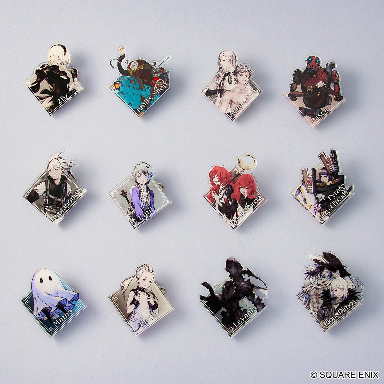Collection of character pins from the series NieR on a grey background