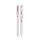 A white retractable ballpoint pen shown in two views: closed with a pink clip and cap, and open with pink floral graphics and the text 'PIKMIN' printed on the barrel, set against a plain white background.