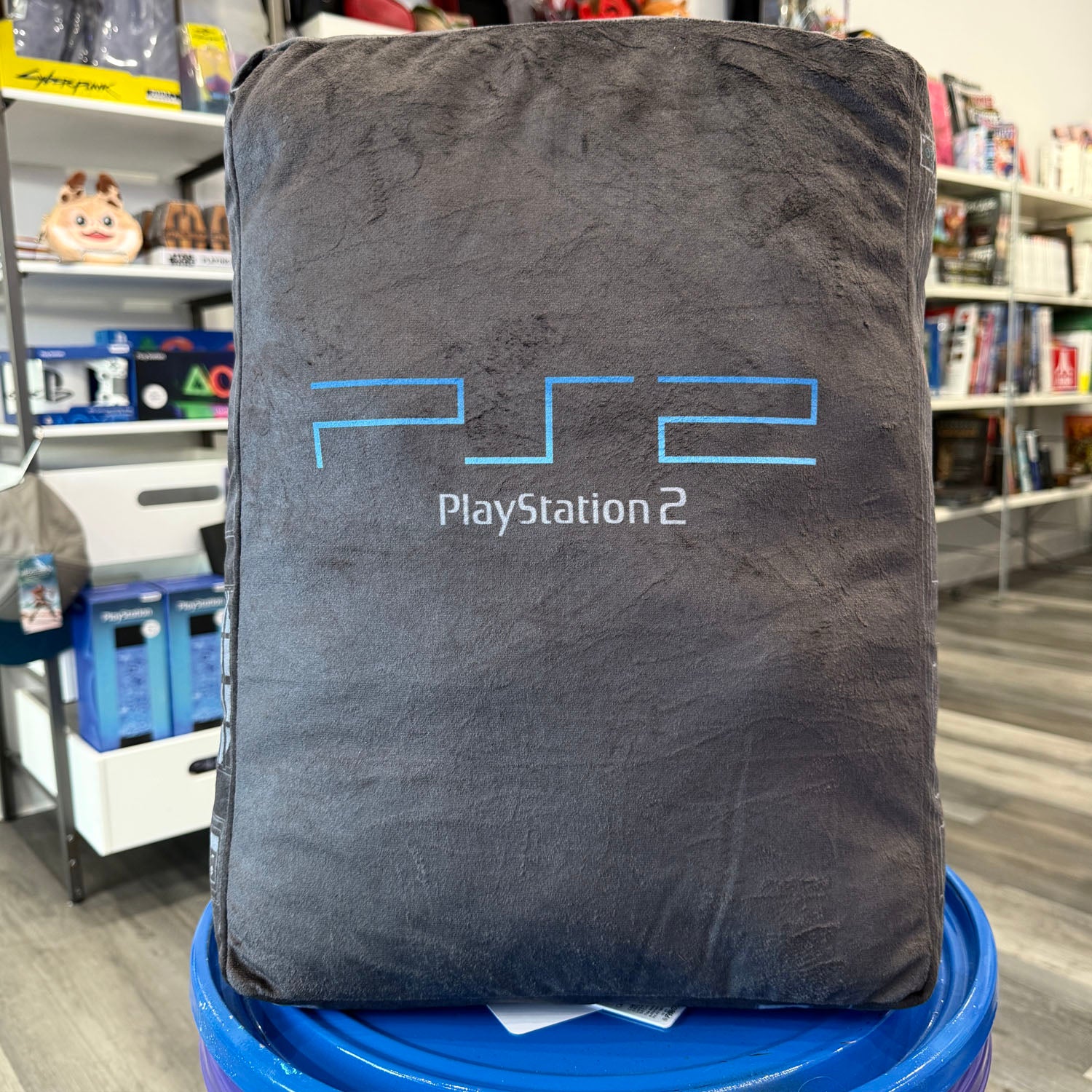 Pillow made to look like a PlayStation 2 console. Black with blue logo. 