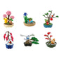 Miniature Pokemon figurines sitting on planters. Shows 6 different designs on a white background. 
