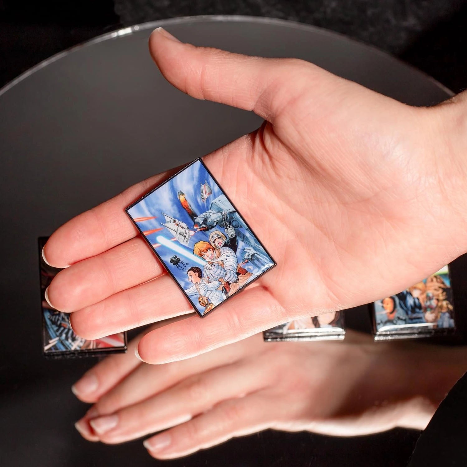 Hand holding a Star Wars pin